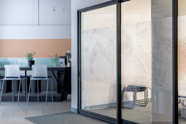 industrial style sleek aluminium sliding doors and minimalist kitchen area
