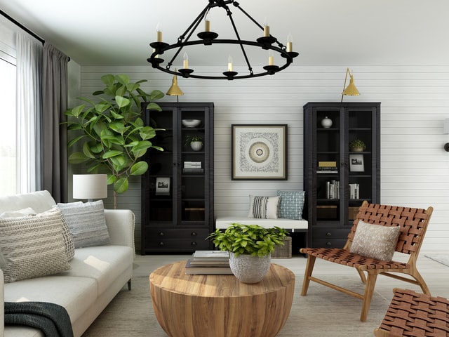 farmhouse industrial style living room, with wicker chairs, wooden coffee table, white wooden walls, sleek black bookshelves and a white fabric sofa with woven cushions