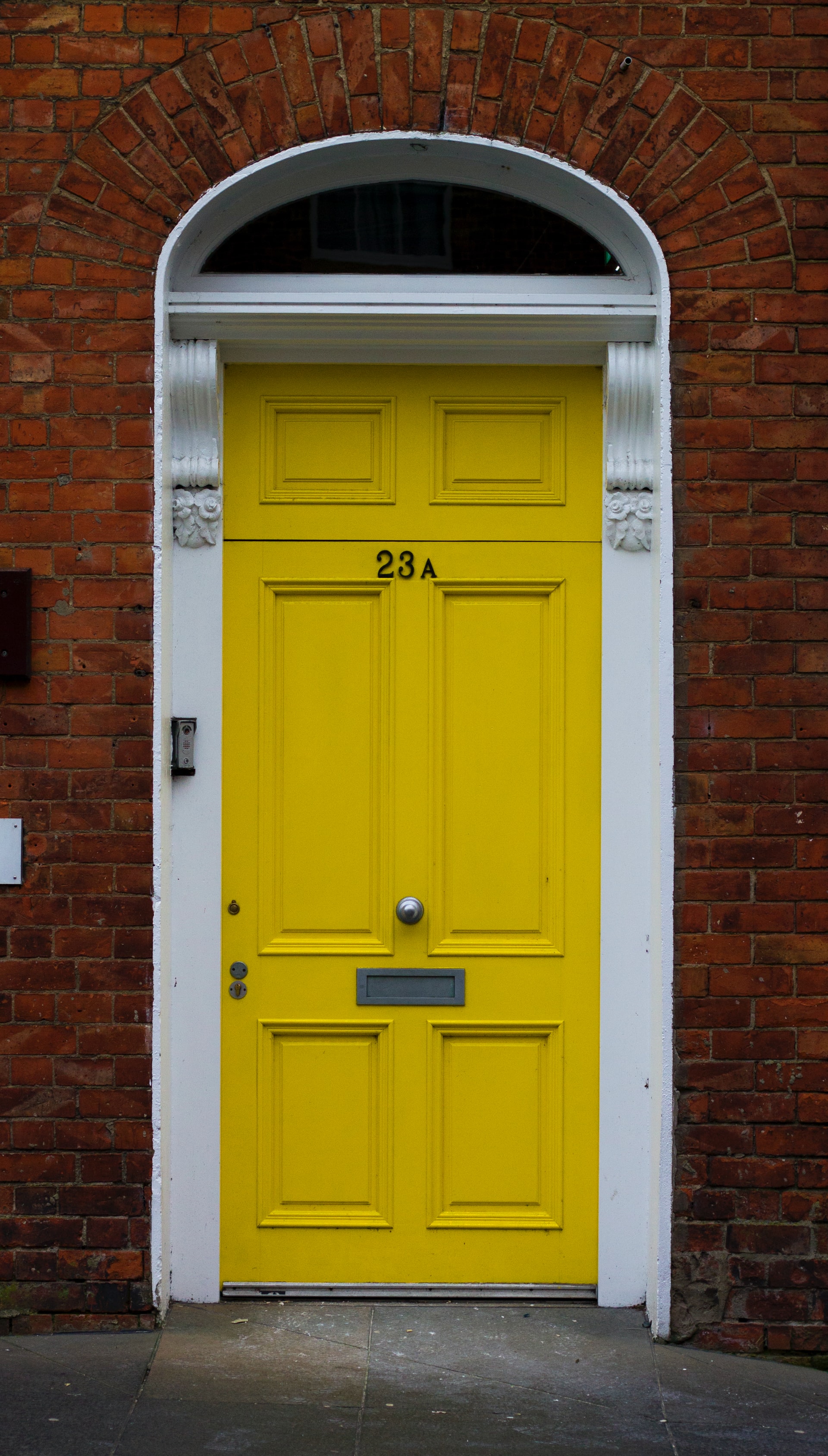 Yellow front door with a white border