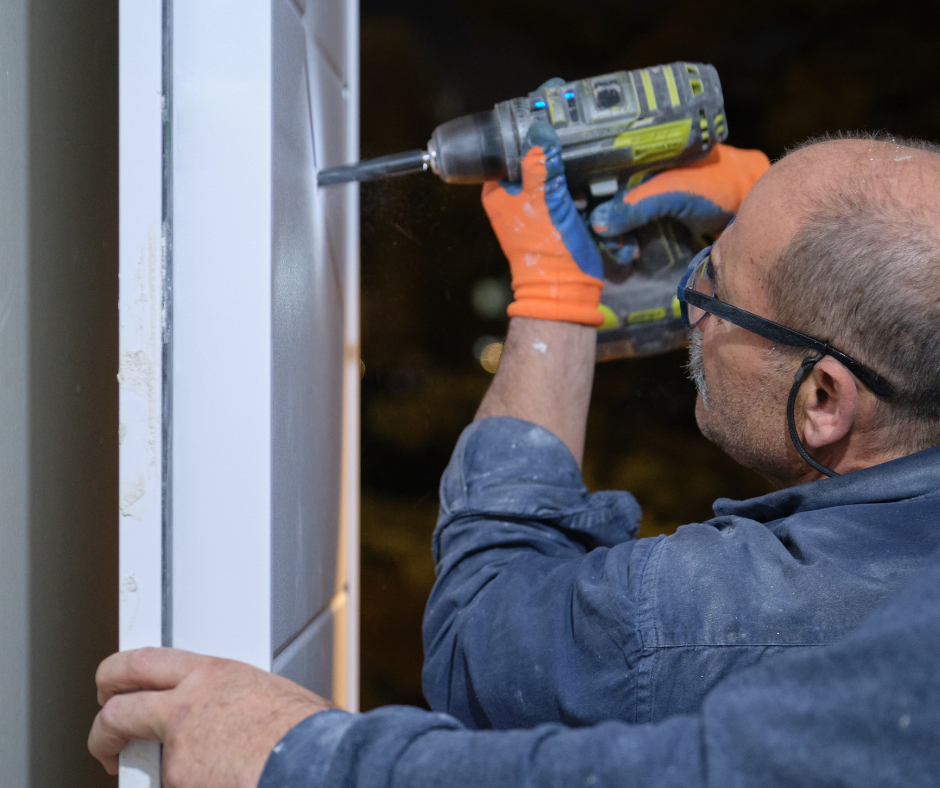 Man drilling a door