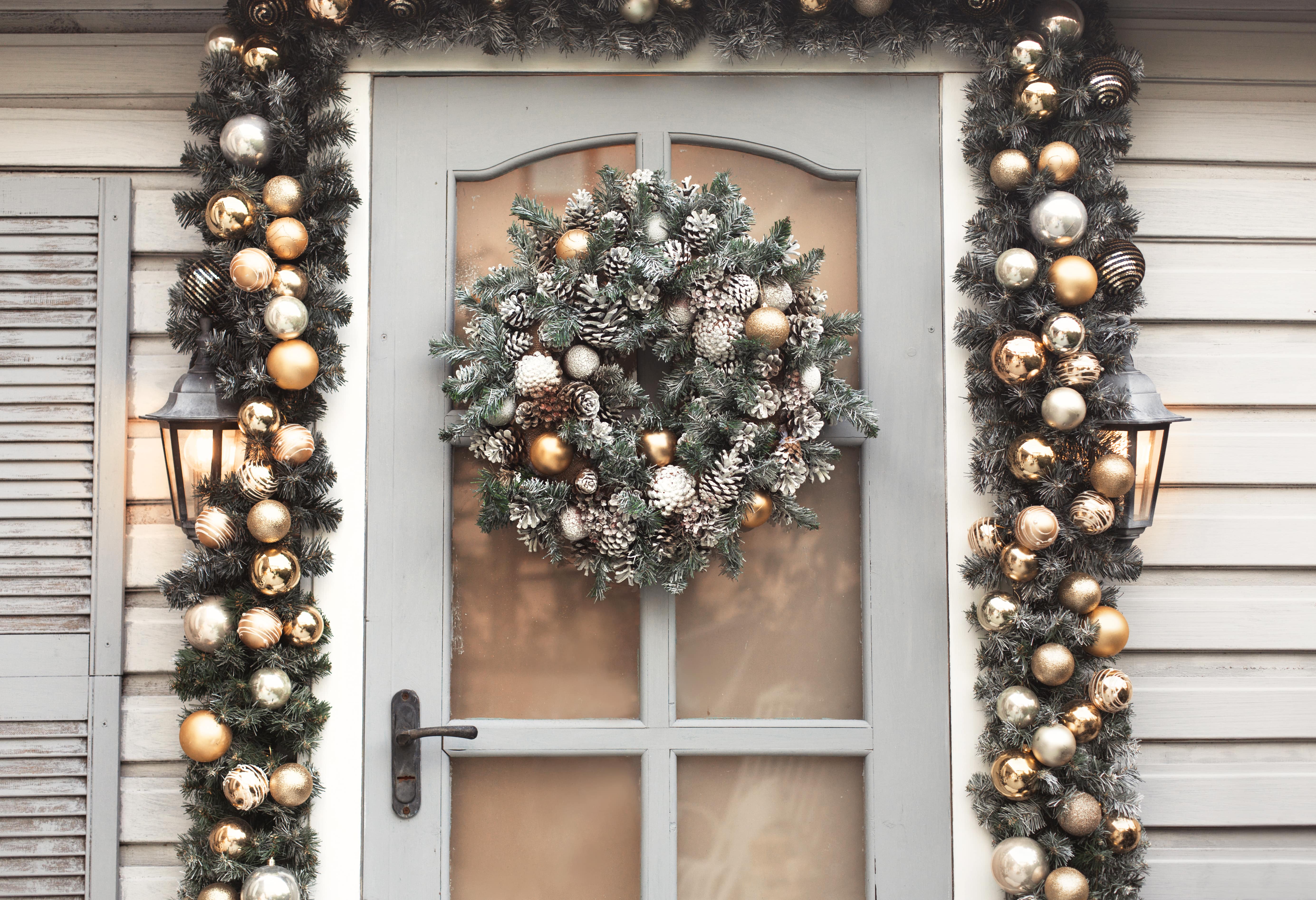 festive entryway with spruce and bauble wreath and garlands
