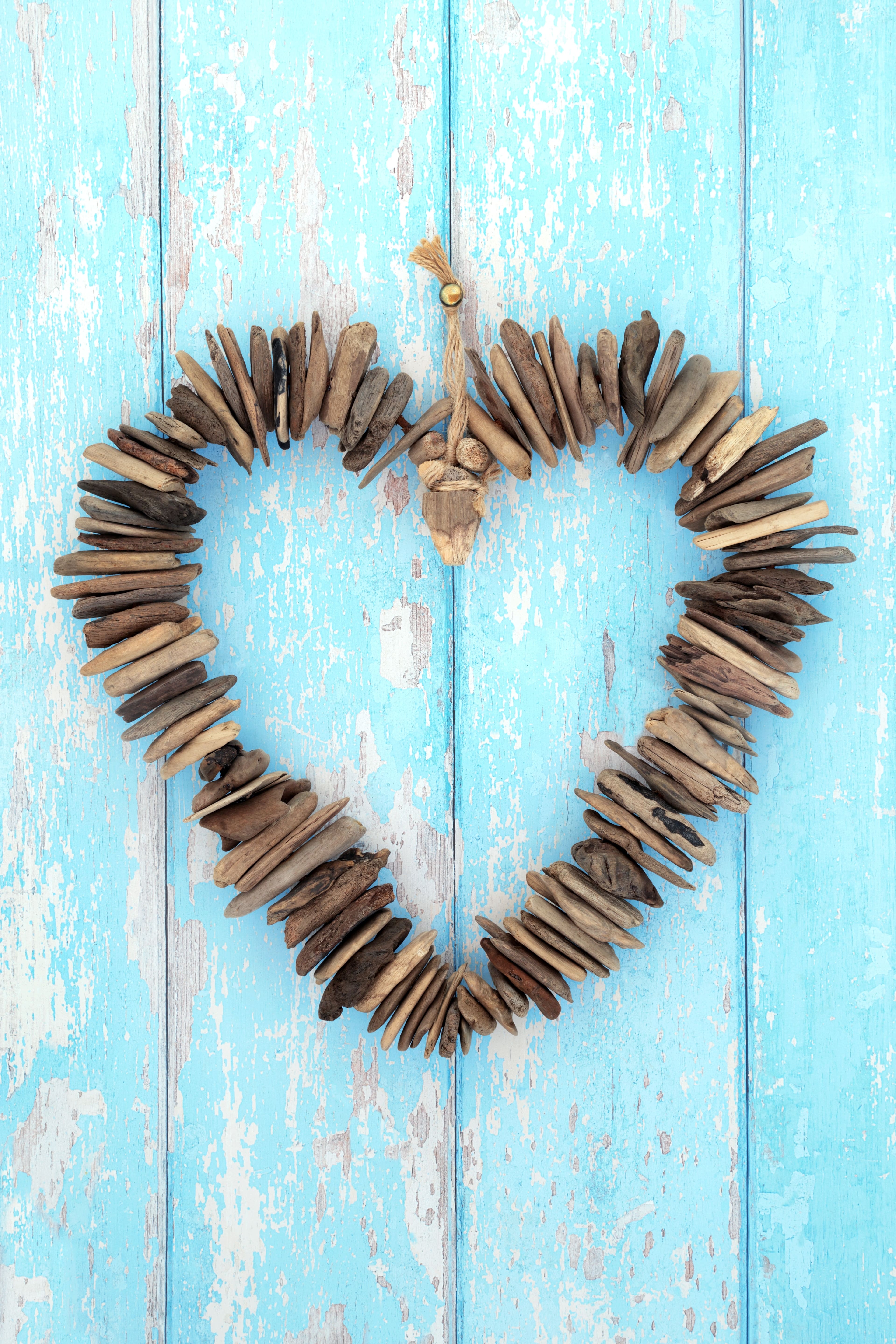 driftwood heart shaped wreath hanging on door