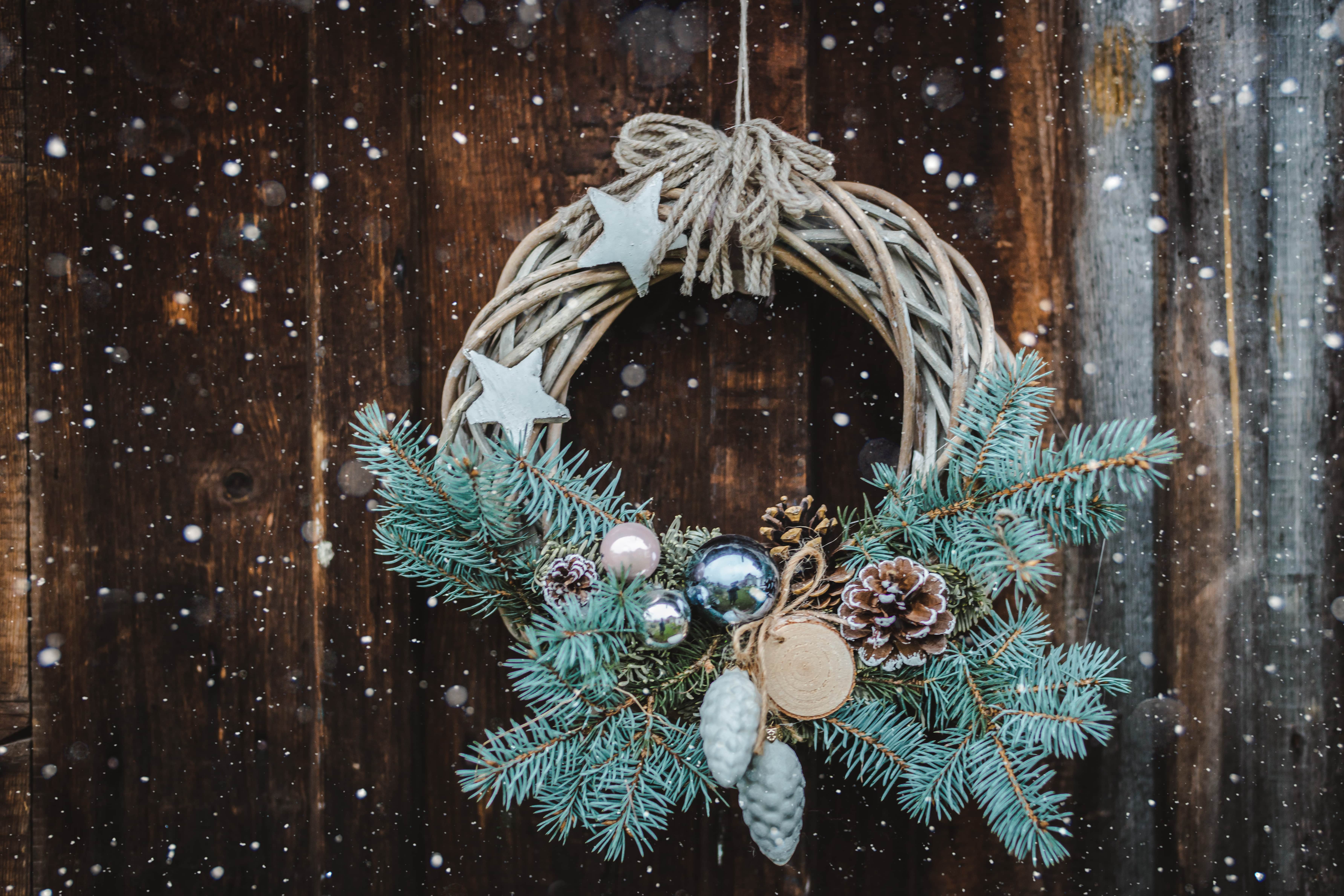 spruce and pinecone Christmas wreath on front door
