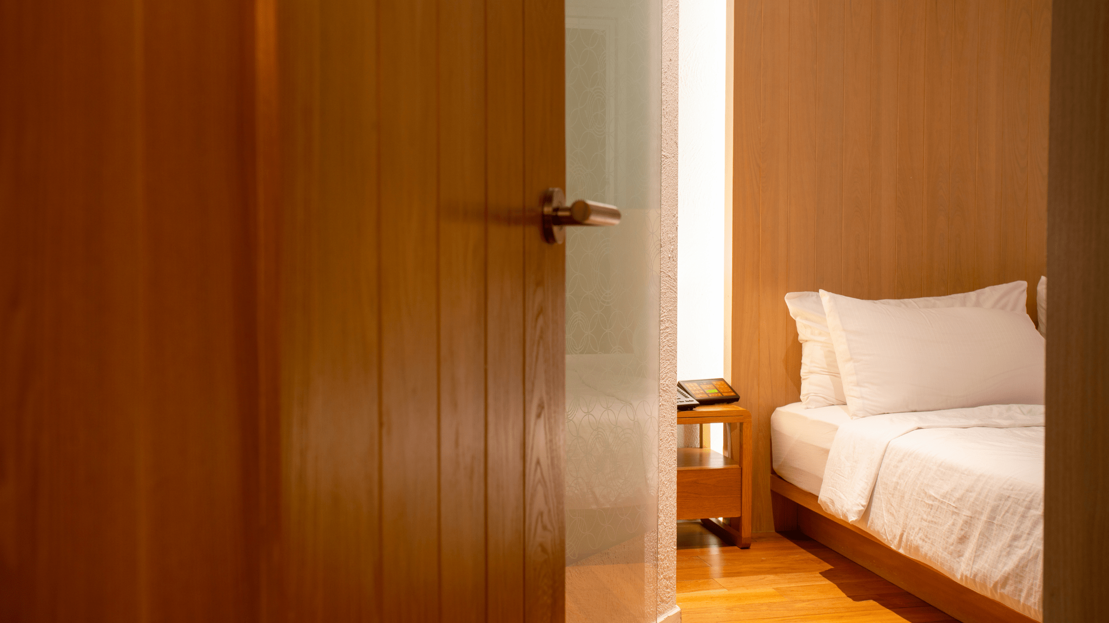 Oak wooden doors opening into a bedroom